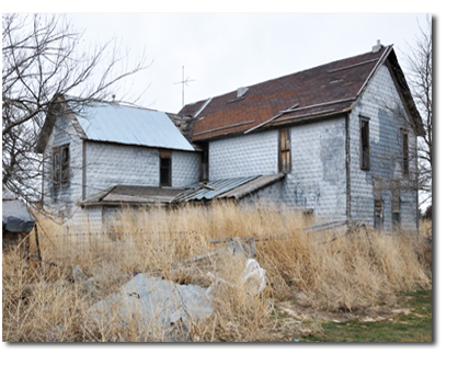 An old house by the railroad tracks in Monument, Kansas